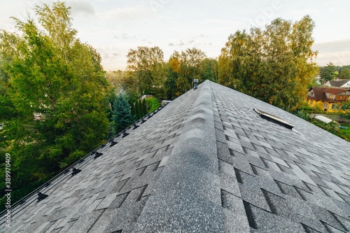 new renovated roof covered with shingles flat polymeric roof-tiles photo