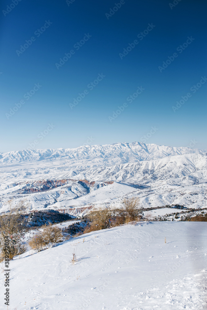 An incredibly beautiful panorama of the winter mountains of the Tien Shan in Uzbekistan