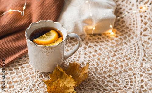 Cup of warm tea fall style, fall scene with leaves, l, cozy autumn aesthetic concept