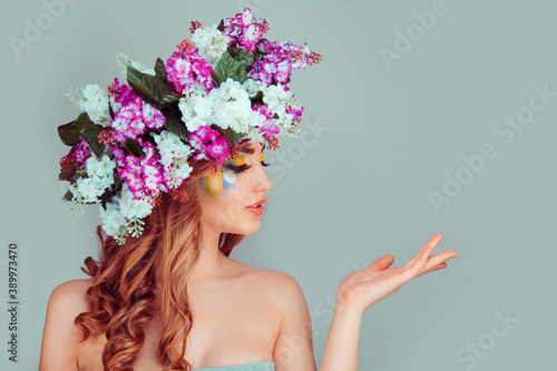 woman in profile with floral lilac headband showing pointing with hand