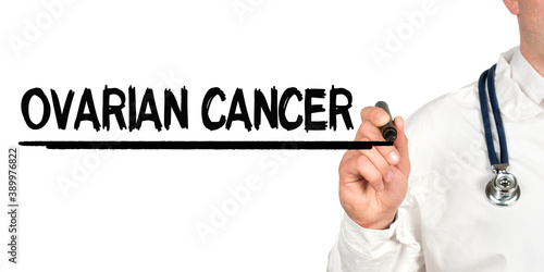 Doctor writes the word - OVARIAN CANCER. Image of a hand holding a marker isolated on a white background.