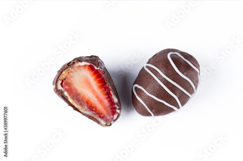 Chocolate truffles with strawberry filling isolated on white background. Closeup photography.