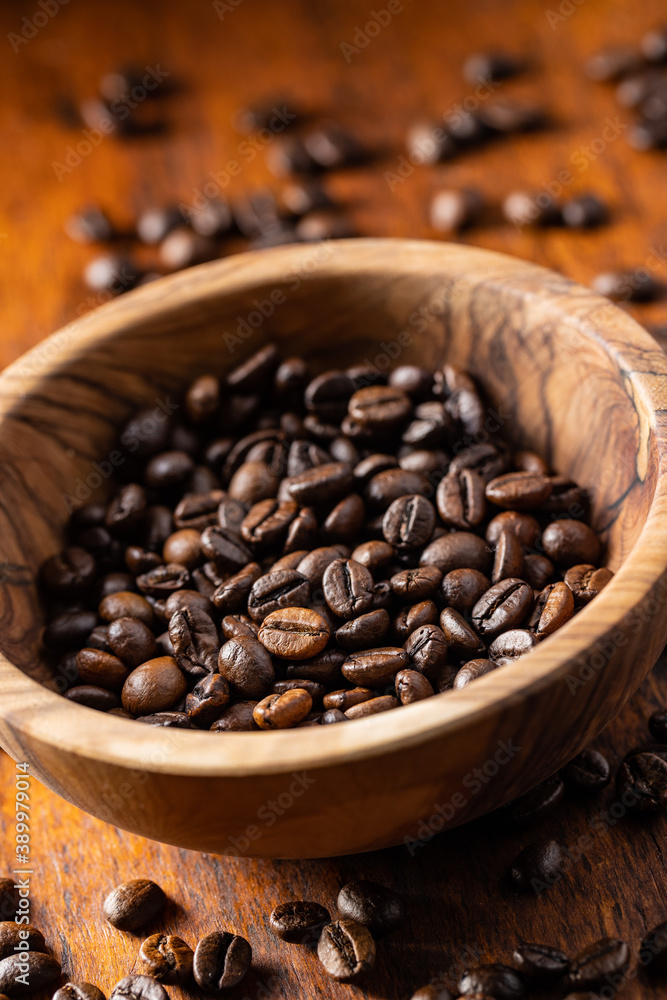 Roasted coffee beans in wooden bowl Roasted coffee beans in wooden bowl