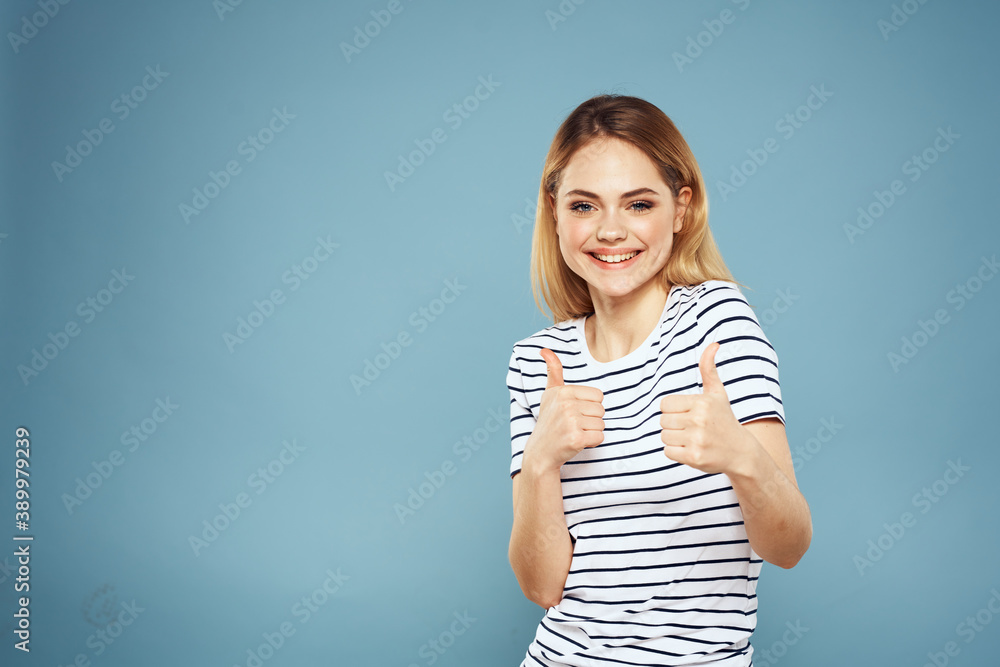 Pretty woman striped t-shirt fun emotions lifestyle blue background Pretty woman striped t-shirt fun emotions lifestyle blue background