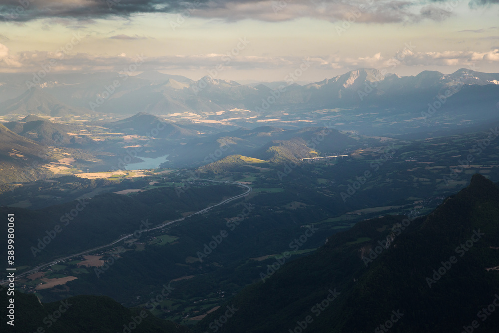 aerial view of mountains with a lake at sunset