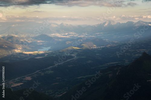 aerial view of mountains with a lake at sunset