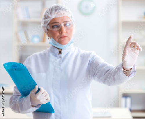 Woman doctor pressing buttons in lab