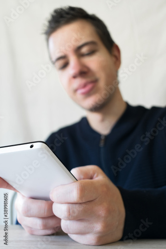 Caucasian young man using his mobile phone photo