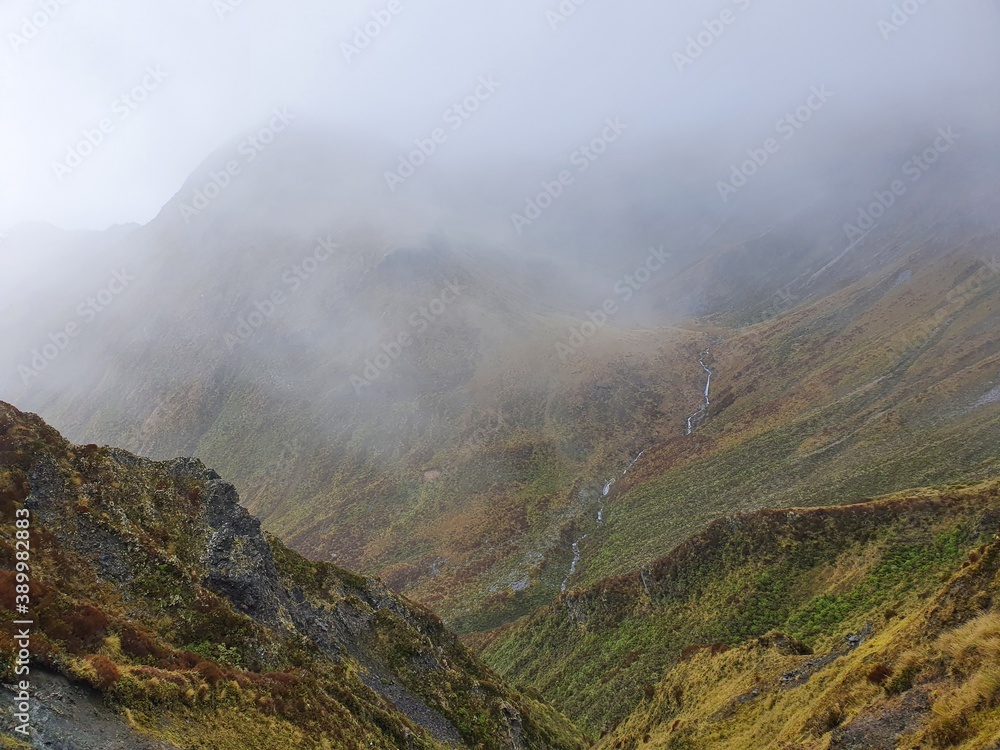 fog in the mountains
Distant waterfall 
New Zealand 
Kepler