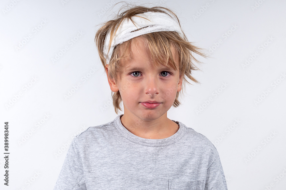 Portrait young caucasian cute boy blond hair with trauma injury and bandage  head. Isolated on white background. Calm emotions Stock Photo | Adobe Stock