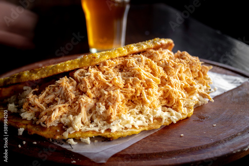 Venezuelan cachapa with cheese and a glass of beer photo
