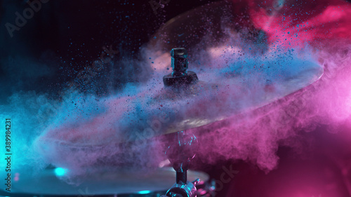 Freeze motion of coloured powder explosion on drum cymbal photo