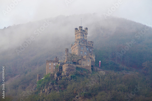 Castle in fog on a mountainside 