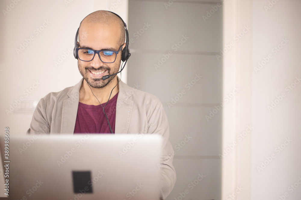 Call center operator is talking with headset. Customer service or Helpdesk concept. Cheerful operator helps his costumers. Caucasian man Call center operator is talking with headset. Customer service or Helpdesk concept. Cheerful operator helps his costumers. Caucasian man