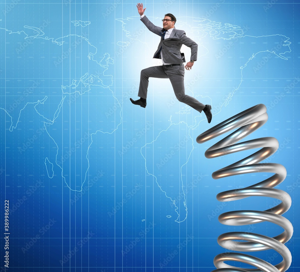 Businessman jumping from spring in promotion concept Businessman jumping from spring in promotion concept