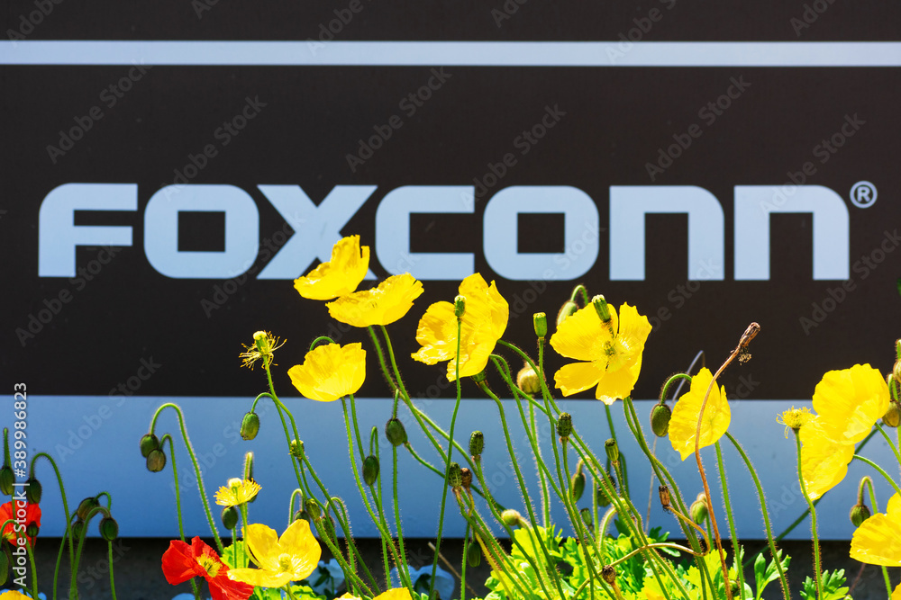 Blurred Foxconn sign in a blooming landscape. Hon Hai Precision Industry  Co., Ltd., trading as Foxconn Technology Group, is a Taiwanese electronics  contract manufacturer - Santa Clara, CA, USA - 2020 Stock