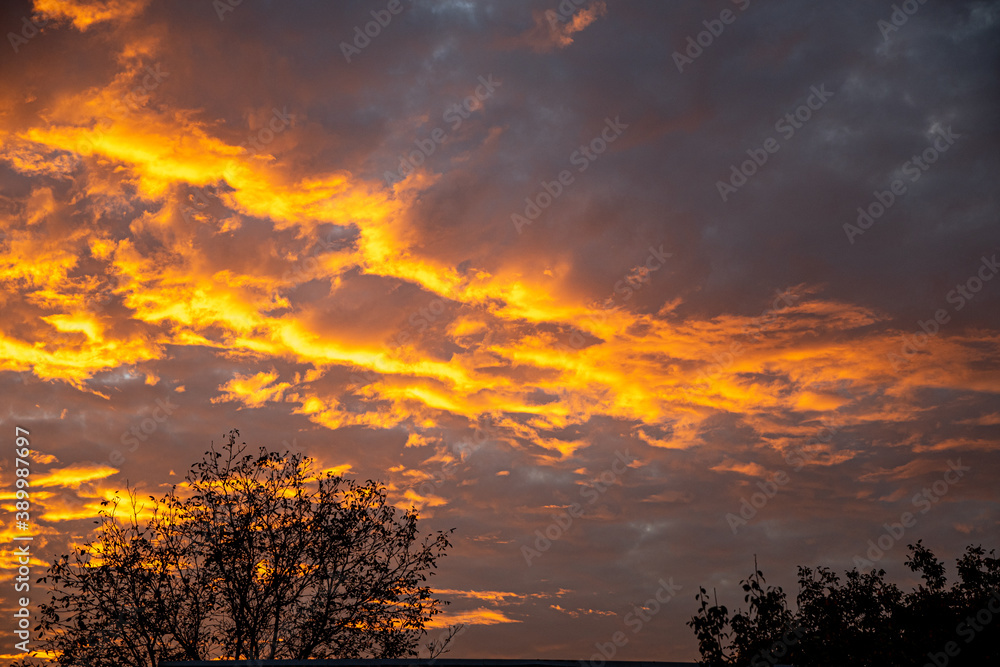 Evening sunset. Yellow, gold, orange clouds on an autumn evening.