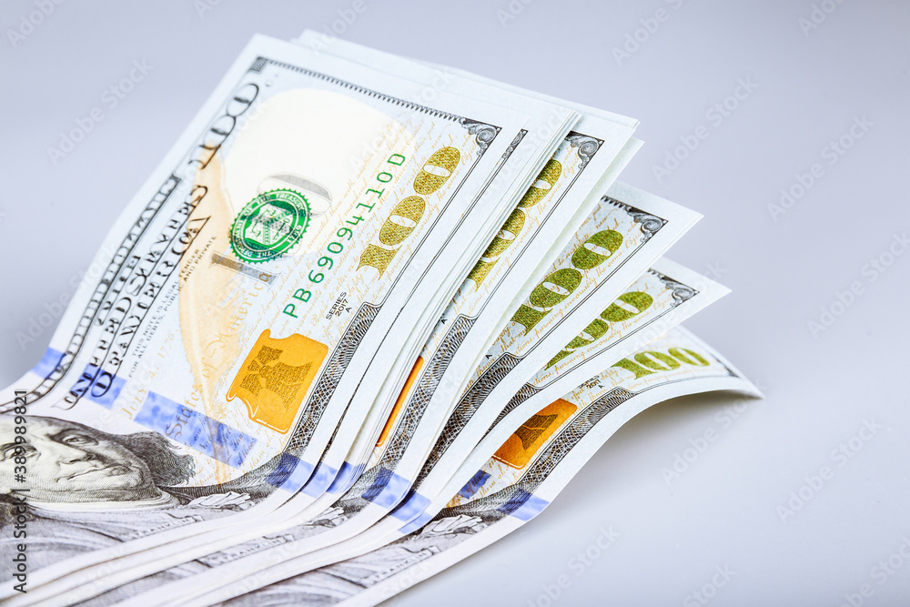 American dollars on a gray background. One hundred dollar bills. American dollars on a gray background. One hundred dollar bills.