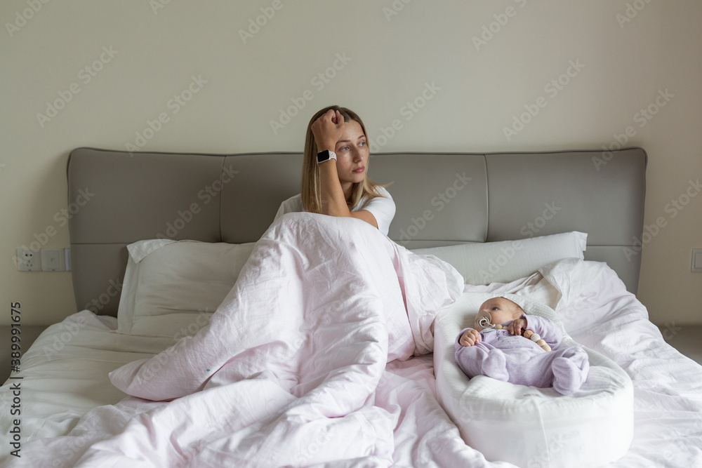 Tired Mother Suffering from experiencing postnatal depression. Health care mom motherhood stressful. Stay at home during coronavirus covid-19 pandemic quarantine Tired Mother Suffering from experiencing postnatal depression. Health care mom motherhood stressful. Stay at home during coronavirus covid-19 pandemic quarantine