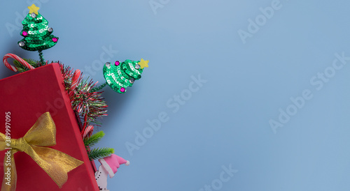 Gift box with Christmas trees, sweets, Santa hat: New Year concept with copy space
