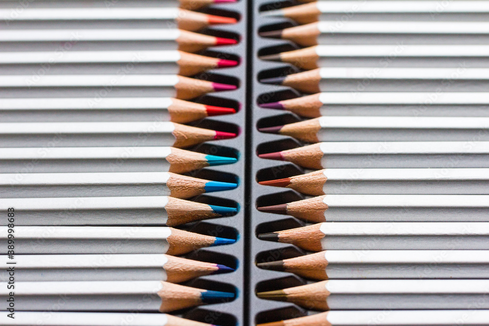 Colored wooden pencils on a black plastic backing Colored wooden pencils on a black plastic backing