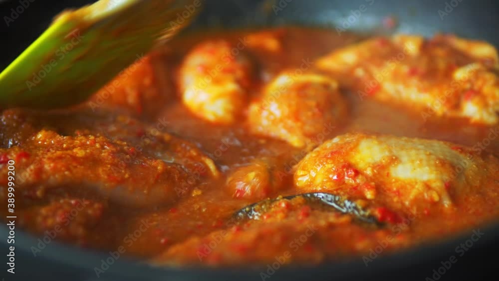 Indian chicken tikka masala spicy curry meat food in cast iron and spices. Grilling Ayam Bakar traditional Indonesian food Indian chicken tikka masala spicy curry meat food in cast iron and spices. Grilling Ayam Bakar traditional Indonesian food