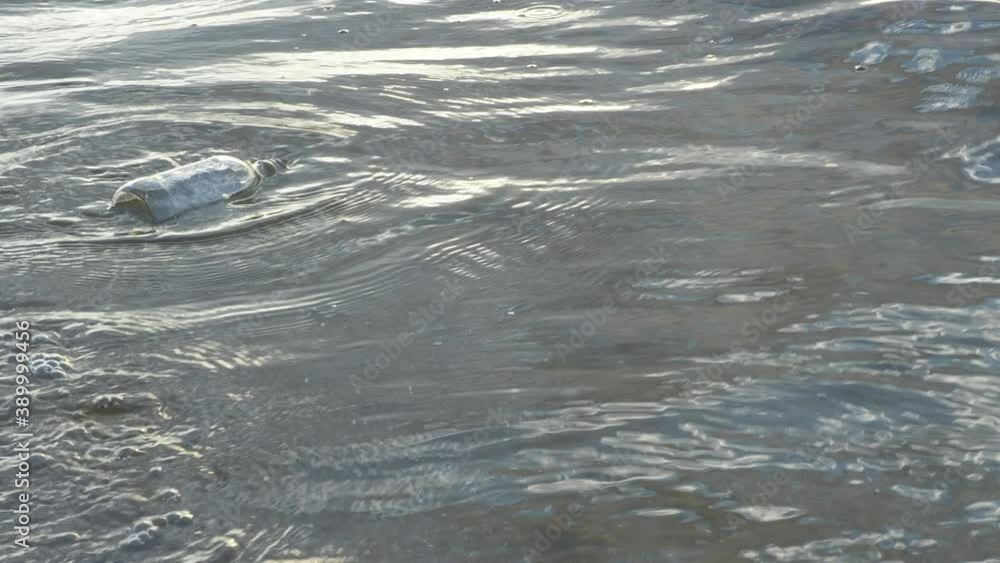 Water pollution garbage glass junk bottle in water, empty used dirty bottle in the concept of nature conservation from pollution, save environmental Water pollution garbage glass junk bottle in water, empty used dirty bottle in the concept of nature conservation from pollution, save environmental
