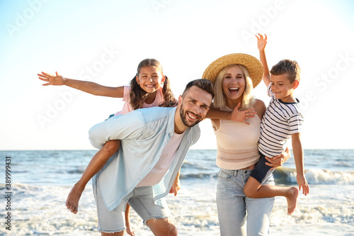 Happy family on beach near sea. Summer vacation © New Africa