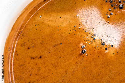 Golden espresso coffee crema texture. Speciality coffee  extraction concept. photo