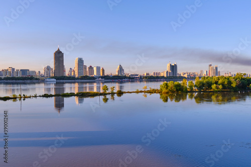 A view of skyscrapers on the banks of the Songhua River in Harbin, China photo