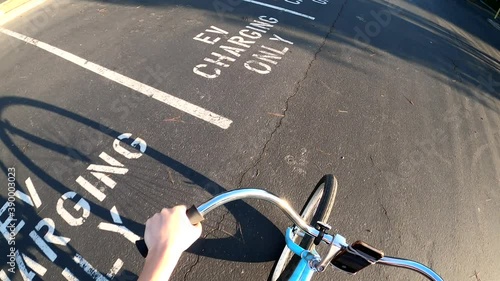 Empty electric vehicle charging stations in the heart of Silicon Valley's tech company parking lots. POV of someone riding by an empty parking lot at Google's headquarter in Mountain View, CA (USA).