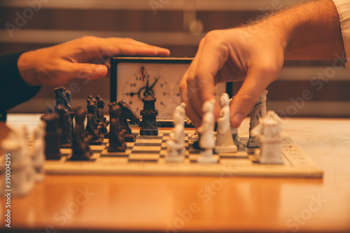 Closeup shot of people playing timed chess