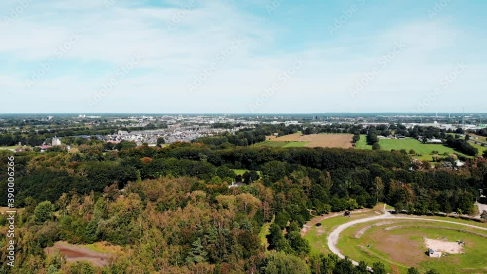 Woodland park forest aerial view above vast parkland trees overlooking suburban cityscape Woodland park forest aerial view above vast parkland trees overlooking suburban cityscape