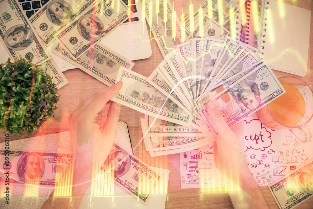 Multi exposure of financial graph drawing hologram and USA dollars bills and man hands. Analysis concept. Multi exposure of financial graph drawing hologram and USA dollars bills and man hands. Analysis concept.