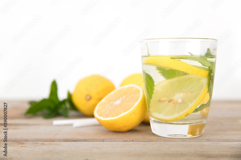 A cup of lemon mint tea and freshly cut lemon fruit A cup of lemon mint tea and freshly cut lemon fruit