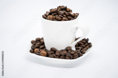 Espresso coffee mug on a white background full of coffee beans
