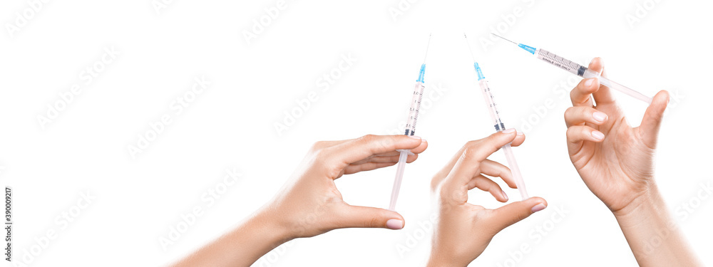 Hand holding syringe with vaccine against corona virus.