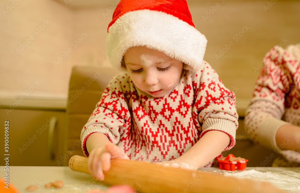 Funny boy is baking Christmas cookies. Boy with rolling pin in kitchen Funny boy is baking Christmas cookies. Boy with rolling pin in kitchen