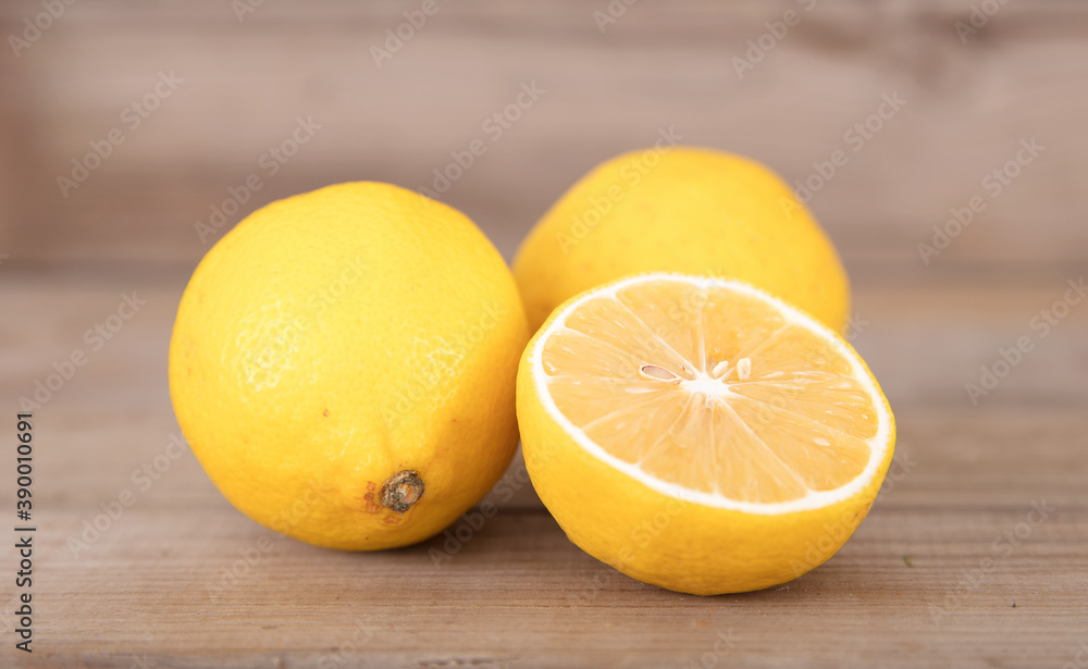 Two fresh lemons and half a cut lemon Two fresh lemons and half a cut lemon