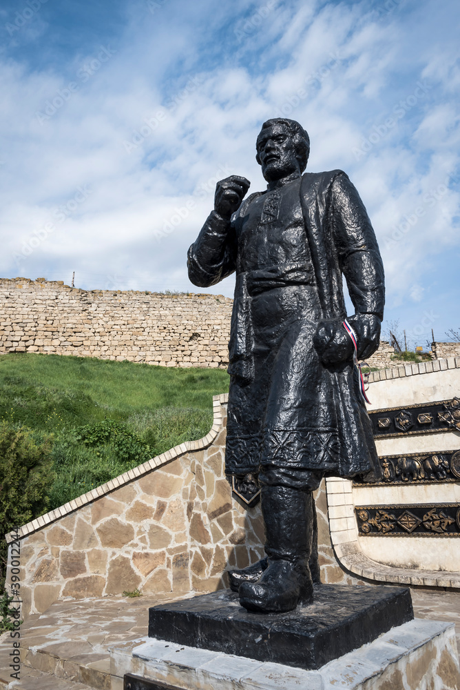 Naklejka premium The monument to famous traveler Afanasy Nikitin, who was in Kafa (now Feodosia) in 1474, against the walls of the Genoese fortress