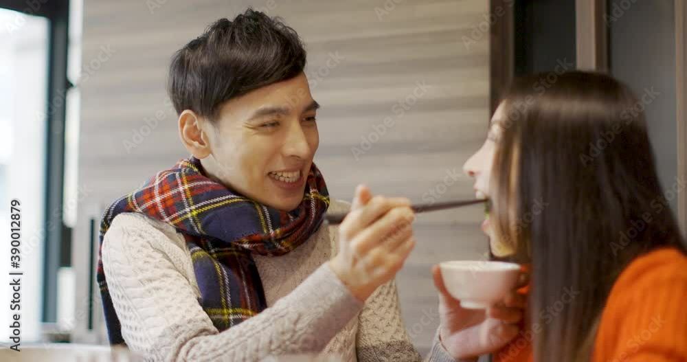 Young man is feeding his girfriend in restaurant
Young man is feeding his girfriend in restaurant