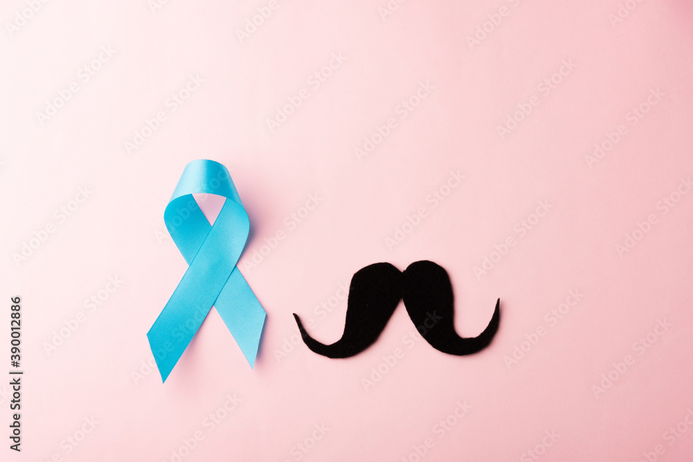 Black mustache paper and light blue ribbon, studio shot isolated on pink background, Prostate cancer awareness month, Fathers day, minimal November moustache concept Black mustache paper and light blue ribbon, studio shot isolated on pink background, Prostate cancer awareness month, Fathers day, minimal November moustache concept