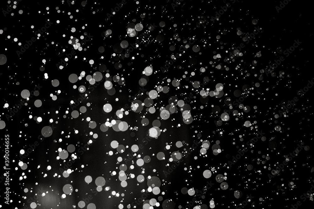 Abstract elegant glitter sparkle bokeh defocused on black background