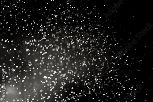 Abstract elegant glitter sparkle bokeh defocused on black background