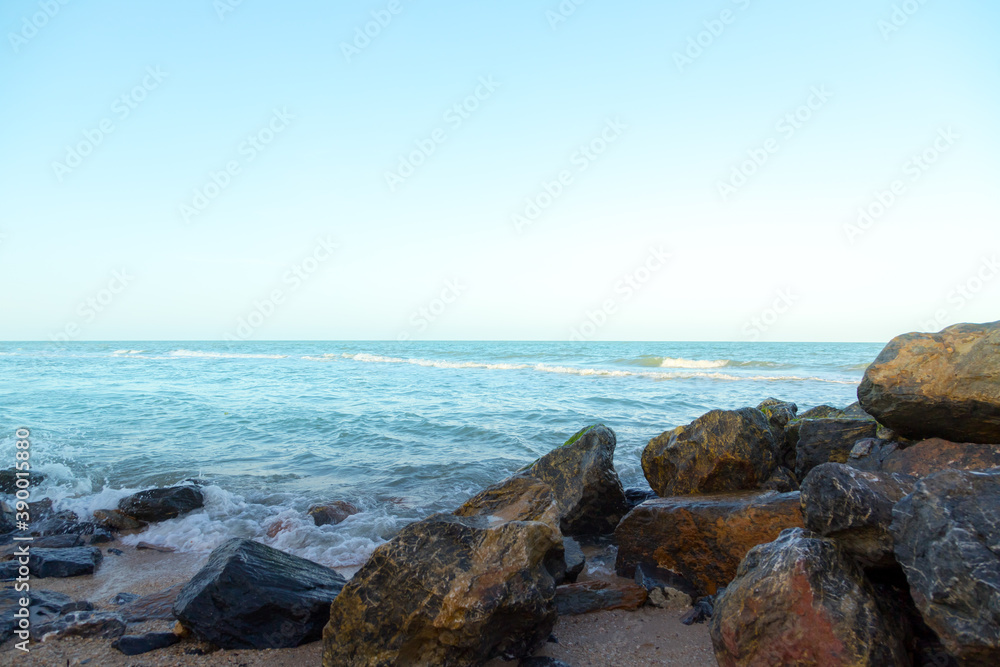 Waves on the seaside rocks are splashing on the rocks natural background