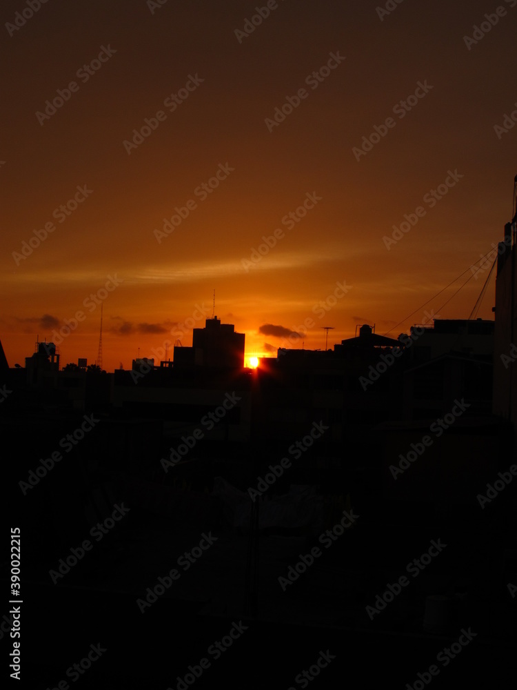 silhouettes of buildings with the sunset behind