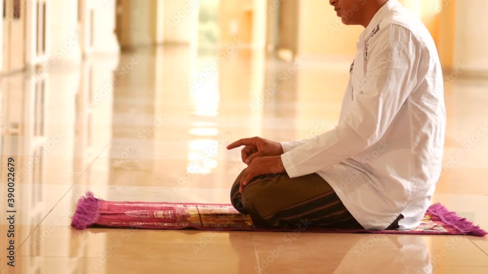 Muslim Indonesian young man praying for Allah at the mosque. Religious muslim Asia man praying inside the mosque. Muslim Indonesian young man praying for Allah at the mosque. Religious muslim Asia man praying inside the mosque.