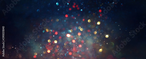 background of abstract red, blue, gold and black glitter lights. defocused