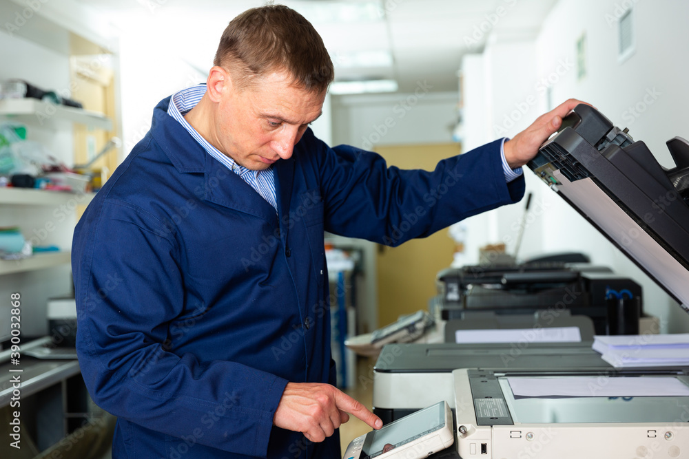 Obraz premium Service engineer using a copy machine. High quality photo