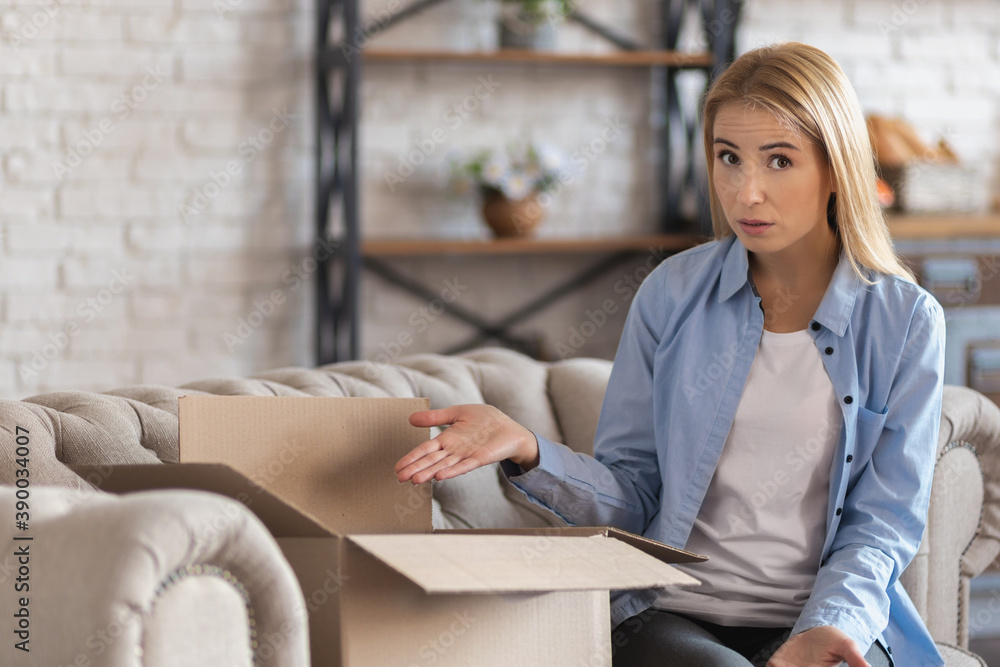 An unhappy customer opened a cardboard package and was upset about the wrong delivery from the Internet An unhappy customer opened a cardboard package and was upset about the wrong delivery from the Internet